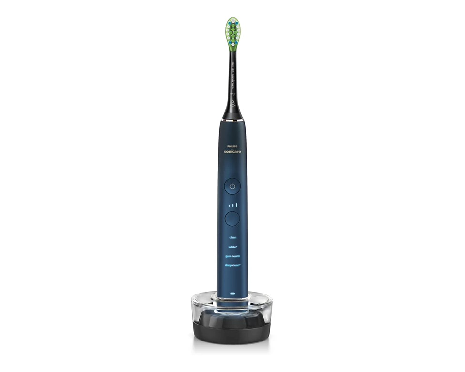 【輪椅王】 Philips Sonicare 9000 系列電動牙刷是電動牙刷，帶有深色手柄，直立在充電底座中。